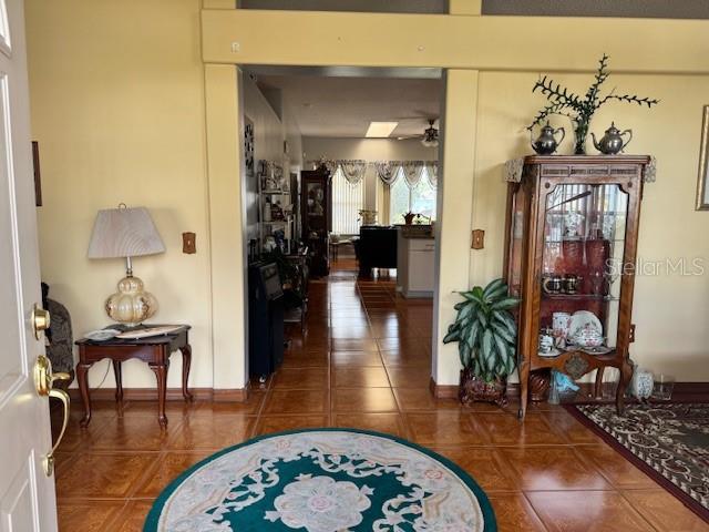 corridor featuring dark tile patterned flooring