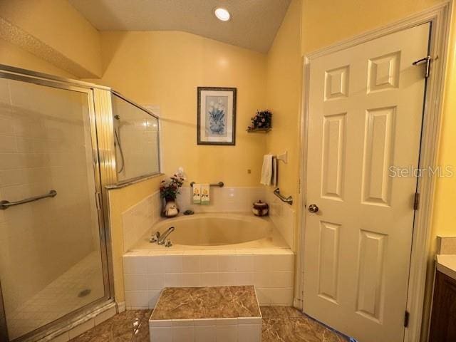 bathroom with lofted ceiling, vanity, and plus walk in shower