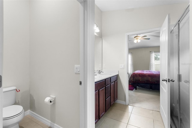 bathroom with ceiling fan, vanity, toilet, and tile patterned flooring