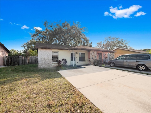 ranch-style home featuring a front yard