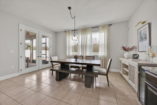 dining space featuring french doors, light tile patterned flooring, and a wealth of natural light