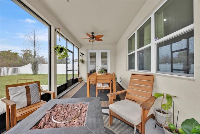 sunroom / solarium featuring ceiling fan and french doors