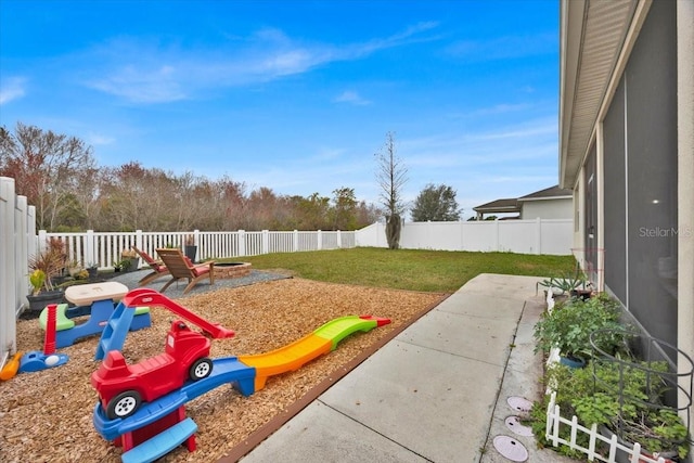 view of yard featuring a playground and a patio