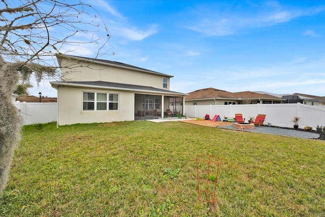 back of house with a yard, a fire pit, and a patio