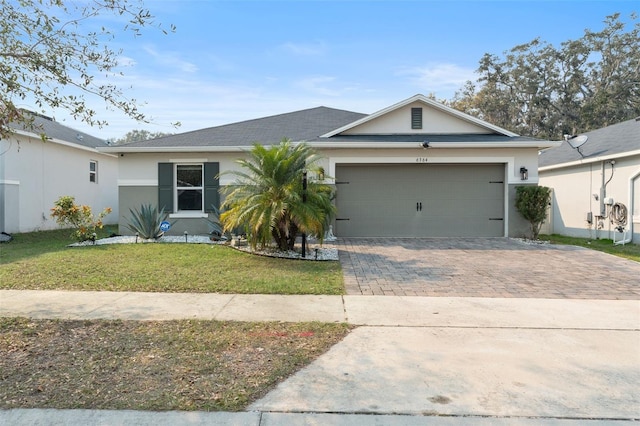 ranch-style house featuring a garage and a front yard