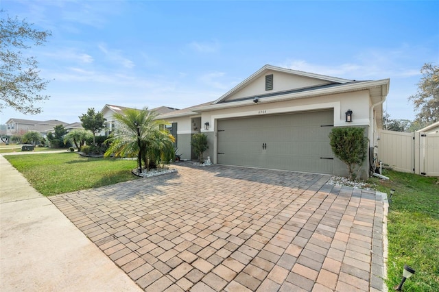 ranch-style home with a garage and a front yard