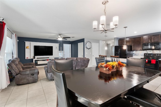 dining room featuring ceiling fan with notable chandelier and light tile patterned flooring