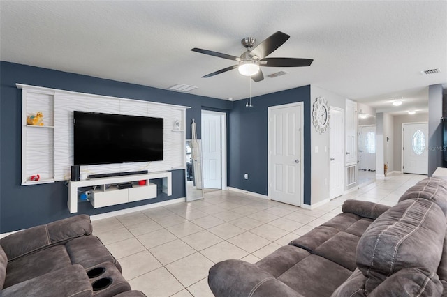 tiled living room featuring ceiling fan and a textured ceiling