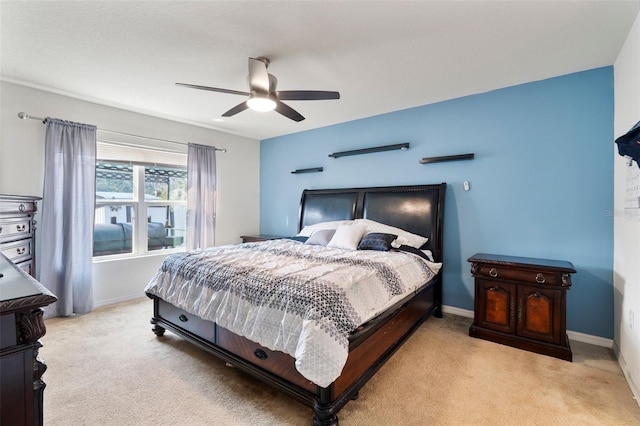 bedroom featuring light colored carpet and ceiling fan