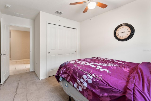 carpeted bedroom featuring a closet and ceiling fan