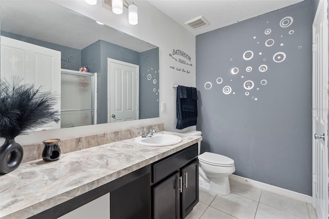 bathroom with vanity, a textured ceiling, a shower with shower door, tile patterned floors, and toilet