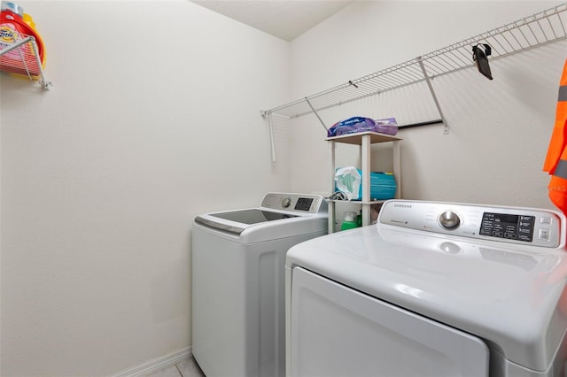 clothes washing area with separate washer and dryer