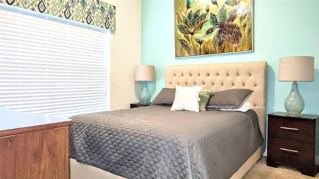 bedroom featuring light colored carpet