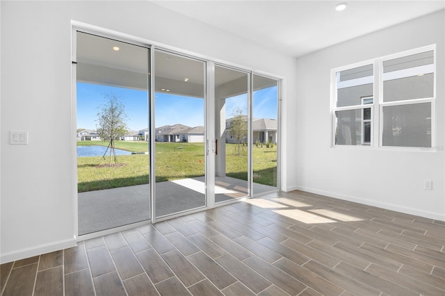 unfurnished room featuring wood tiled floor, baseboards, and recessed lighting