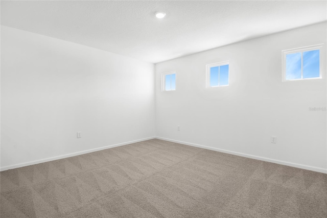 carpeted spare room with baseboards