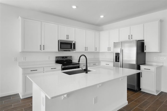 kitchen with white cabinets, wood tiled floor, stainless steel appliances, and a sink