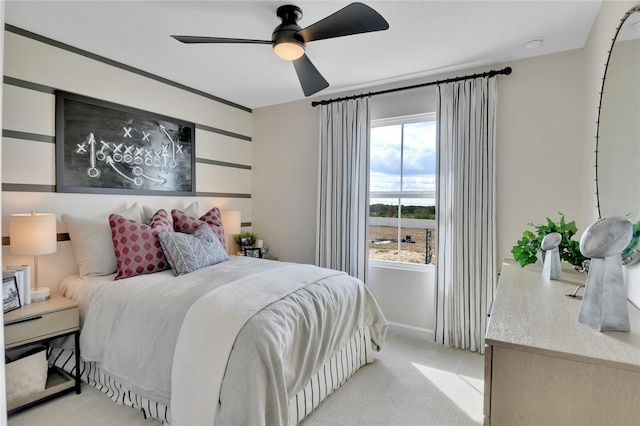 bedroom featuring light colored carpet and ceiling fan