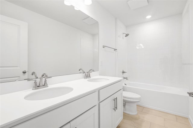 bathroom with toilet, double vanity, shower / washtub combination, and a sink