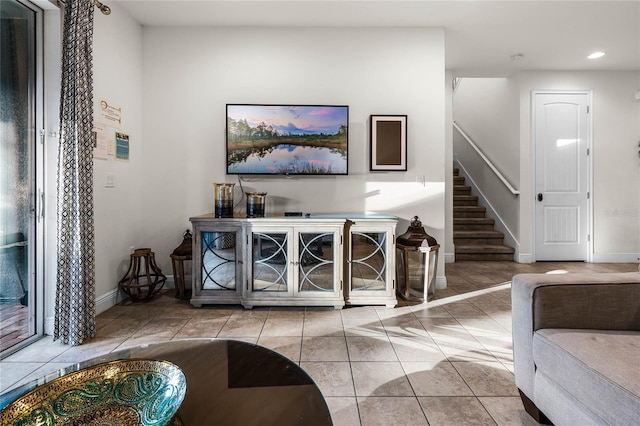 living room featuring recessed lighting, stairway, light tile patterned flooring, and baseboards