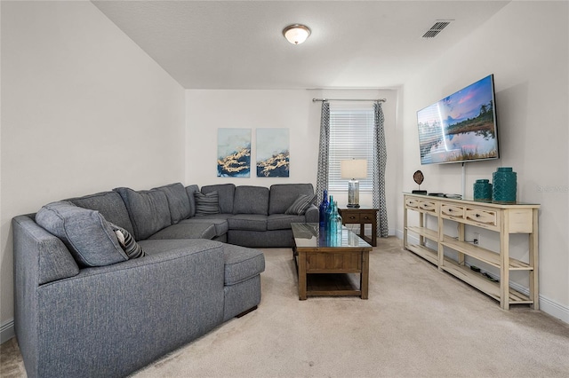 carpeted living area featuring baseboards and visible vents