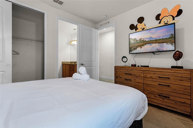 carpeted bedroom with a closet and visible vents