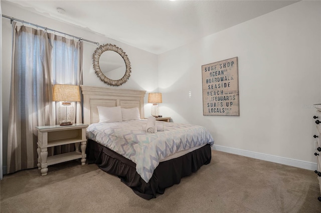 bedroom featuring carpet and baseboards