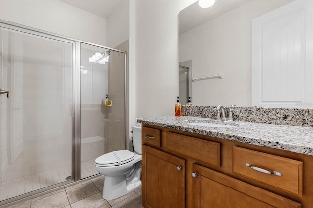 full bath featuring toilet, a shower stall, vanity, and tile patterned floors