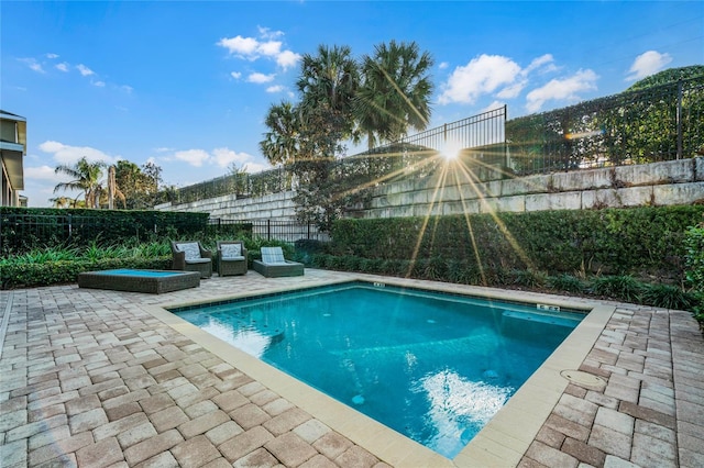 view of pool with a patio, a fenced backyard, a fenced in pool, and an in ground hot tub