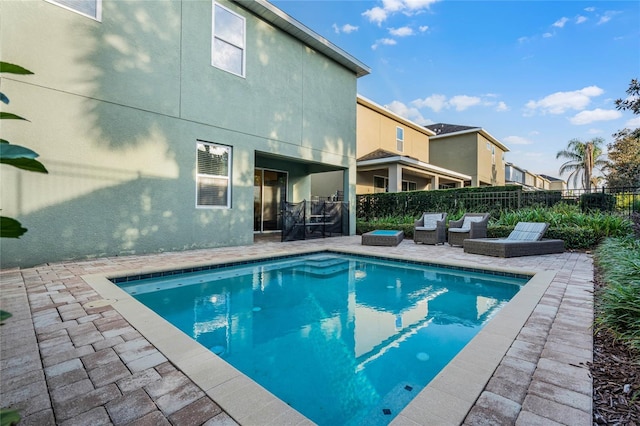 view of pool featuring a patio, fence, and a fenced in pool