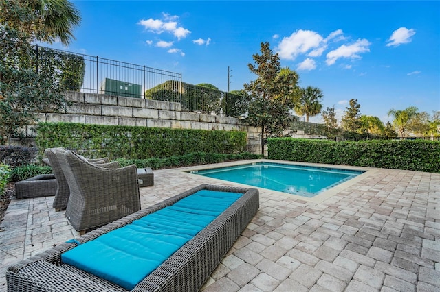 view of pool featuring a fenced backyard, a fenced in pool, and a patio