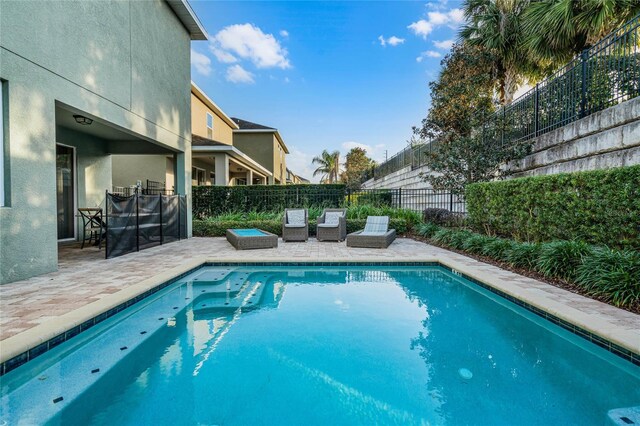 view of swimming pool featuring a fenced in pool, a patio area, and a fenced backyard