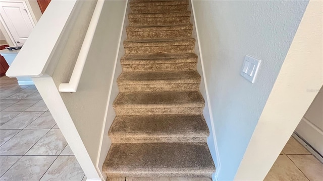 stairs with tile patterned floors