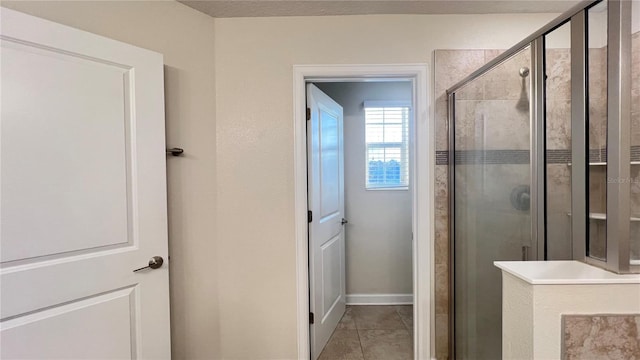 bathroom featuring tile patterned flooring and walk in shower