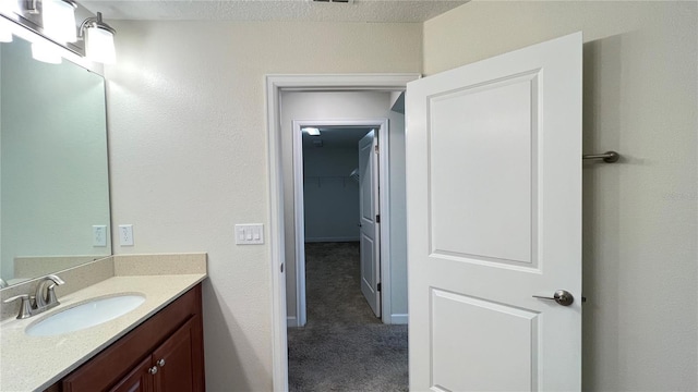 bathroom featuring vanity and a textured ceiling