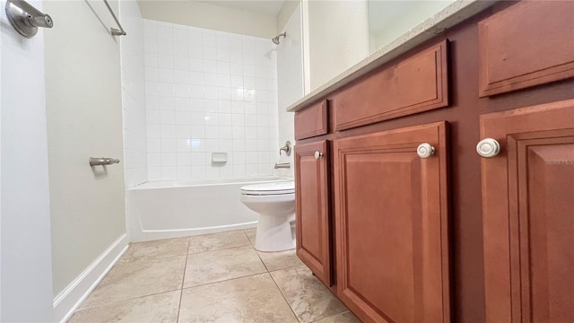 bathroom featuring tiled shower / bath combo, tile patterned floors, and toilet