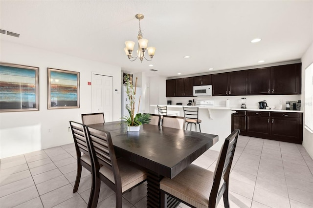 dining room featuring a notable chandelier and light tile patterned flooring