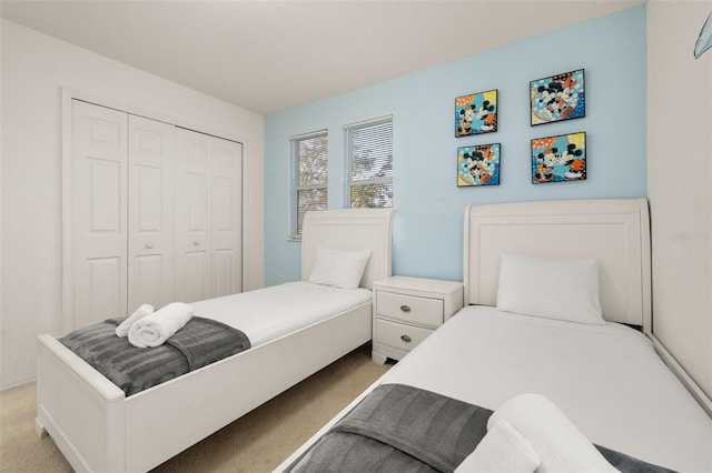 bedroom with light colored carpet and a closet