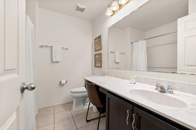 bathroom featuring tile patterned flooring, vanity, and toilet