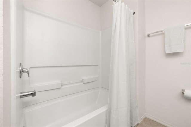 bathroom with shower / bath combo with shower curtain