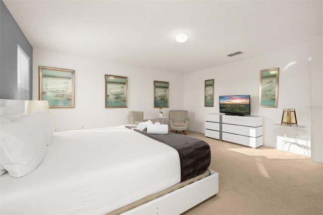 bedroom featuring light colored carpet