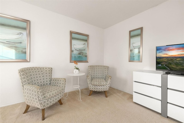 sitting room featuring light colored carpet