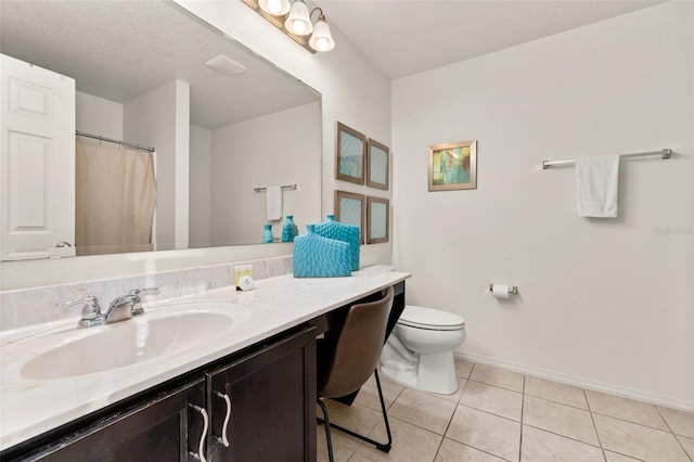 bathroom featuring vanity, a textured ceiling, tile patterned floors, and toilet