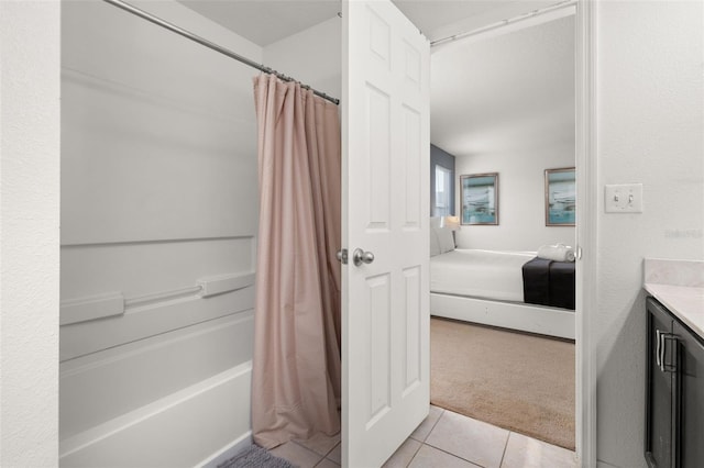 bathroom with shower / tub combo with curtain, vanity, and tile patterned floors