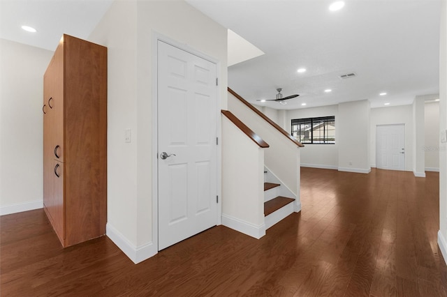 staircase featuring hardwood / wood-style flooring and ceiling fan