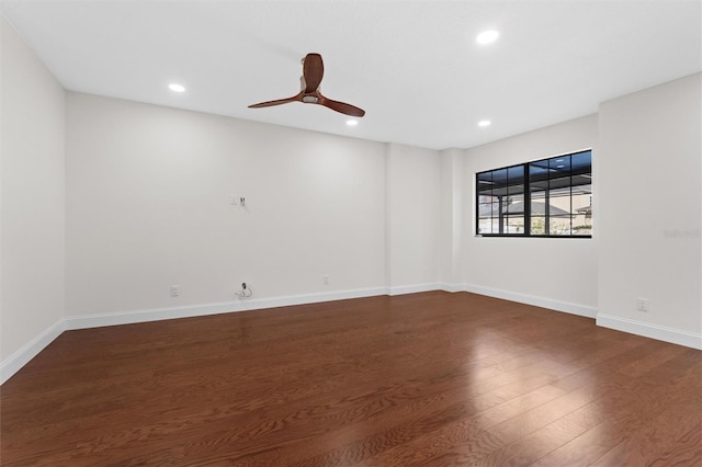 empty room featuring ceiling fan and dark hardwood / wood-style flooring