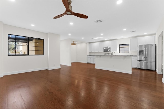 unfurnished living room with dark wood-type flooring, sink, and ceiling fan