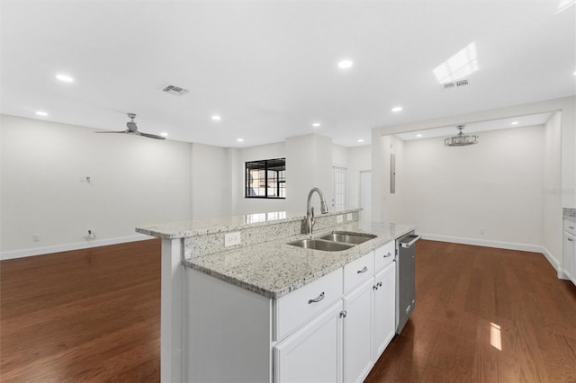 kitchen featuring an island with sink, sink, dark wood-type flooring, and white cabinets