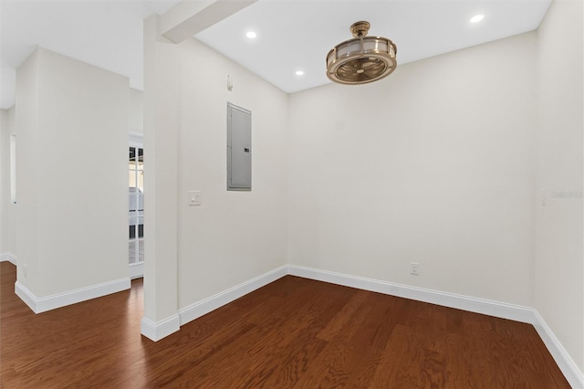 empty room featuring dark hardwood / wood-style floors and electric panel