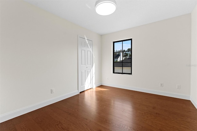 spare room with dark hardwood / wood-style flooring