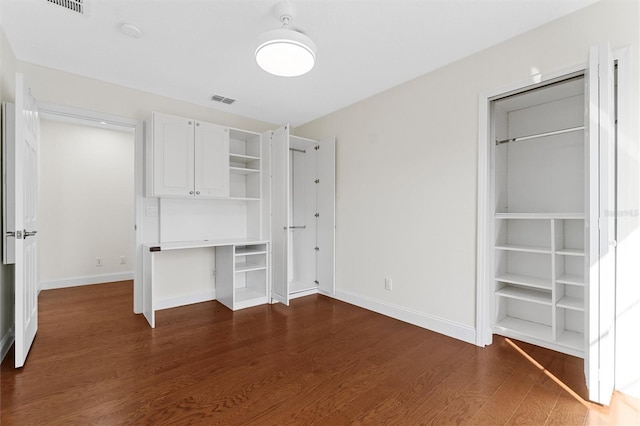 unfurnished bedroom featuring dark hardwood / wood-style flooring